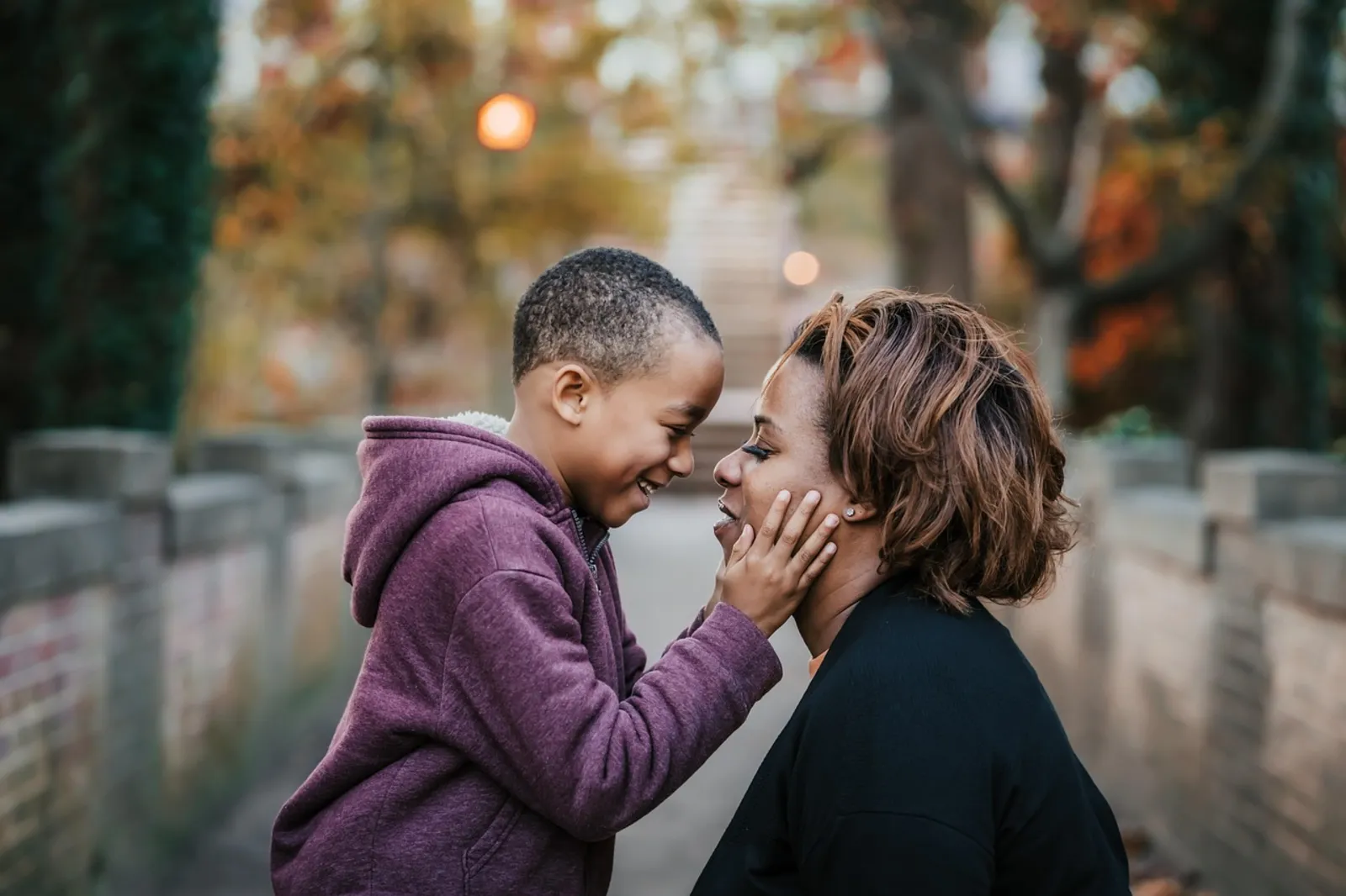 A parent and child sharing a tender moment outdoors